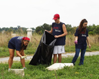 UMBC students pitch in to clean up Mt. Auburn Cemetery in Baltimore City. "Working Together to Preserve a Landmark"