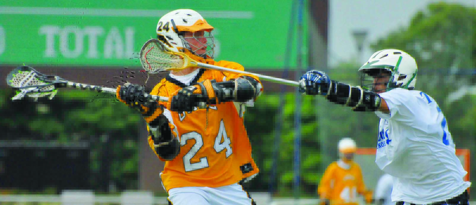 Two lacrosse players lunge for ball