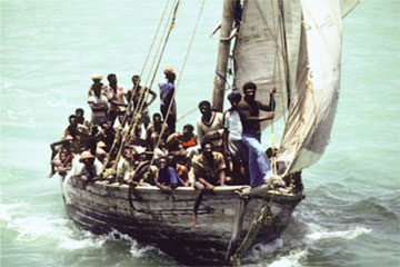 Image of people crowding on a sailboat.