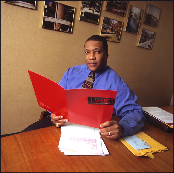 LaMont Toliver in office with folders and papers