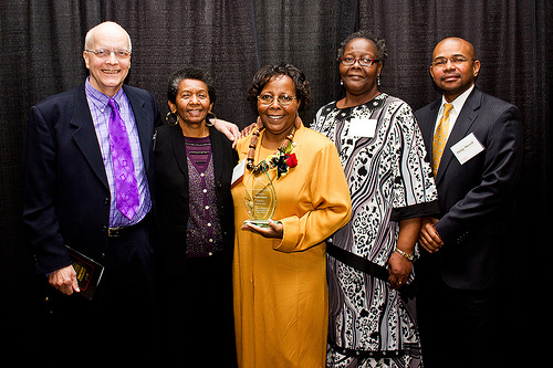 Group of people pose with Legends of Excellence award