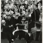 1967 Schamp at podium during graduation