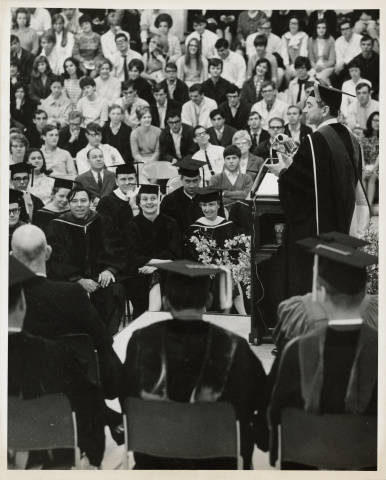 1967 Schamp at podium during graduation