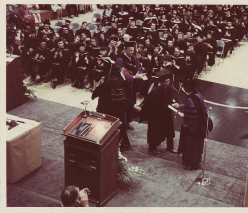 1976 administrators on stage at graduation commencement