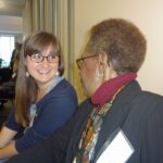 Two women talk at political science reception