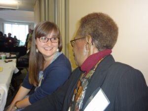 Two women talk at political science reception