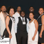 a large group of people dressed in black and white pose at Jazz brunch