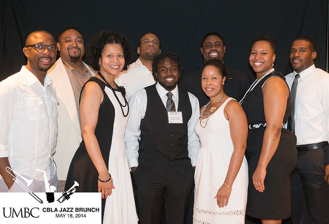 a large group of people dressed in black and white pose at Jazz brunch