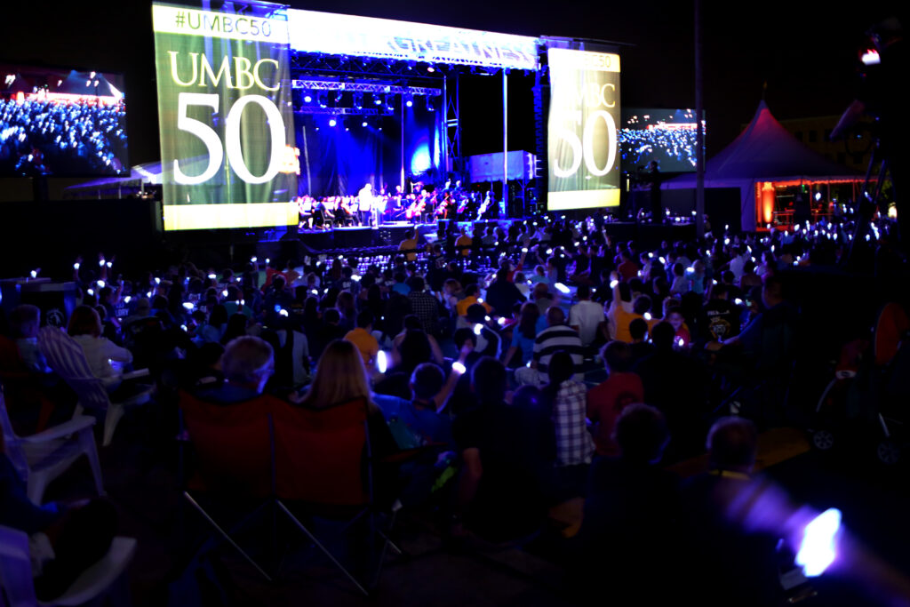A sea of Retrievers wearing glowing bracelets at the festival finale.