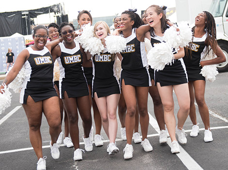 UMBC’s varsity cheerleaders help get alumni into the black and gold spirit at the Dawg Pound.