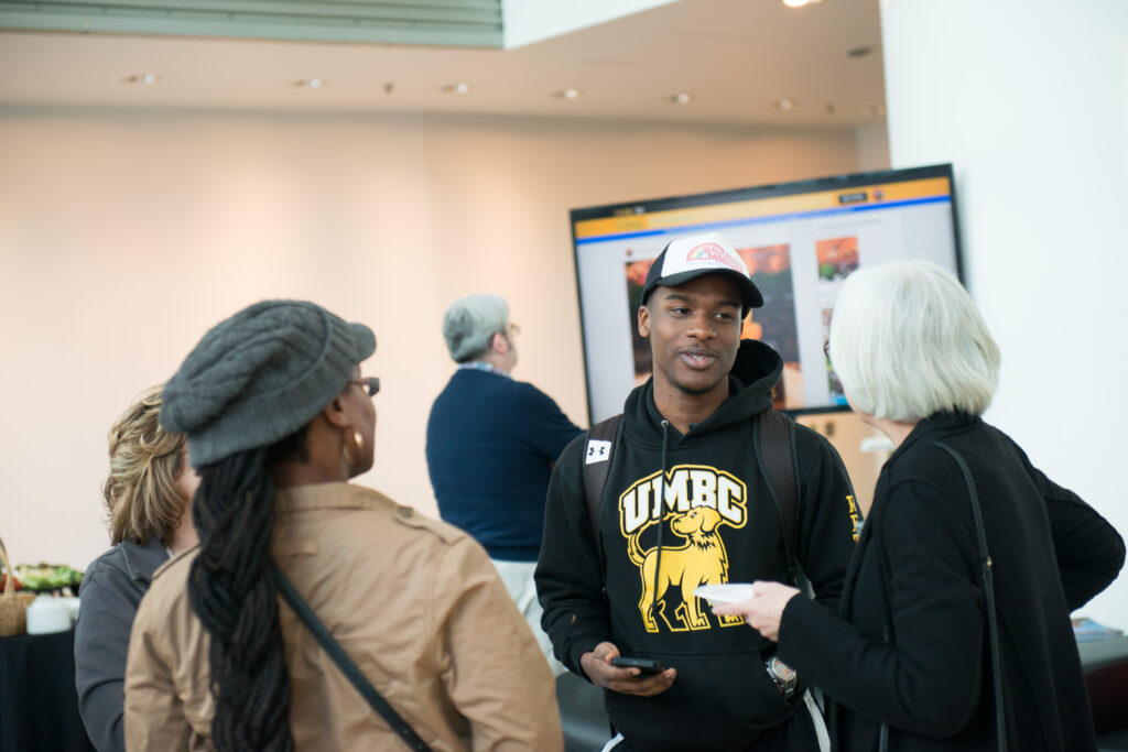 Guests in UMBC's Black and Gold alumni lounge at Light City 2017.