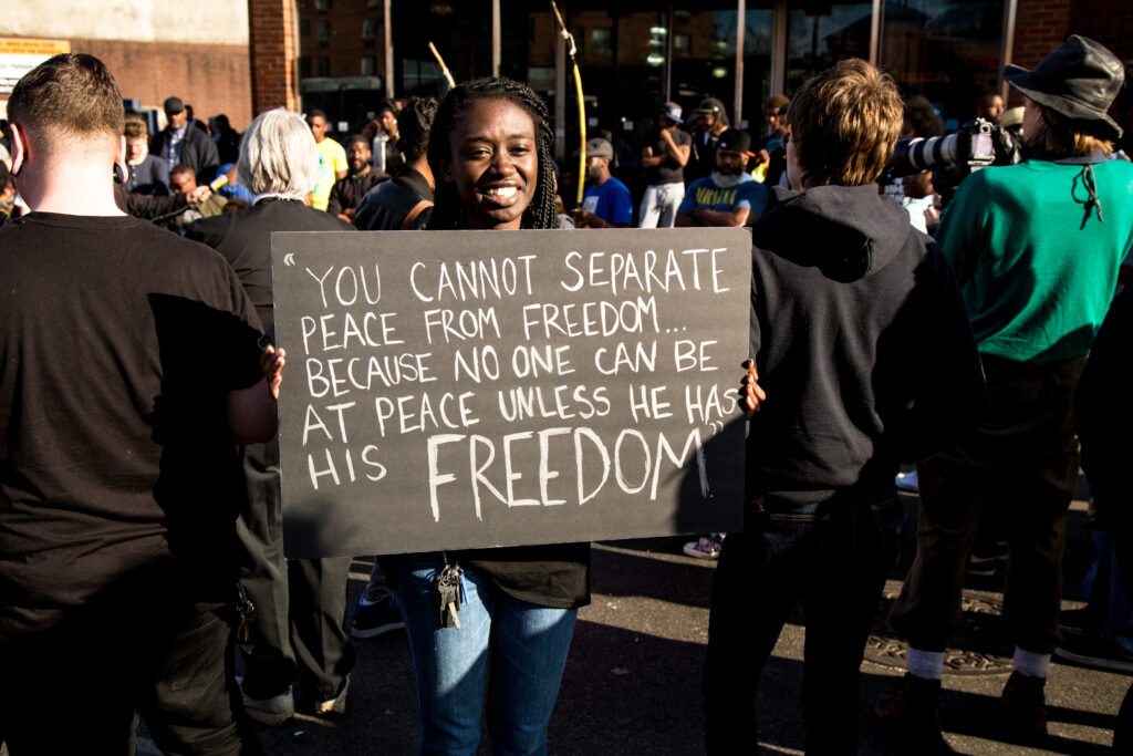 Protester holds sign that reads, 