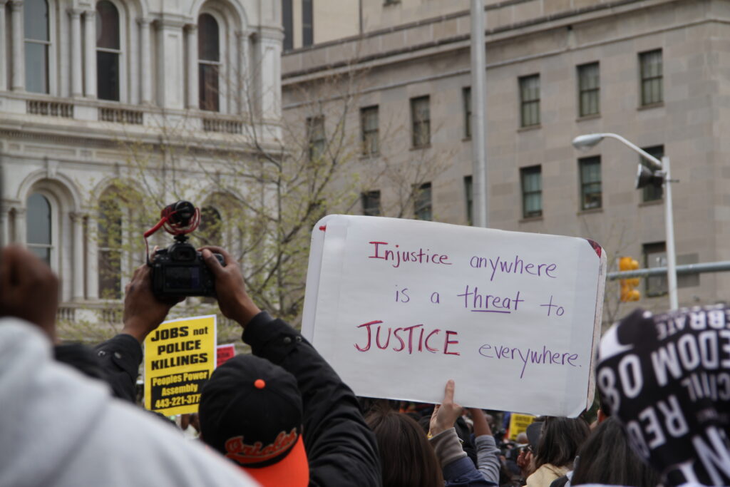 Protester holds a sign reading, 