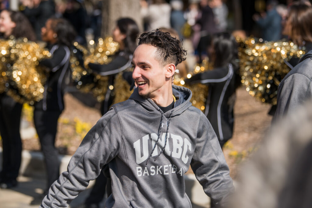 Basketball player smiles in crowd.