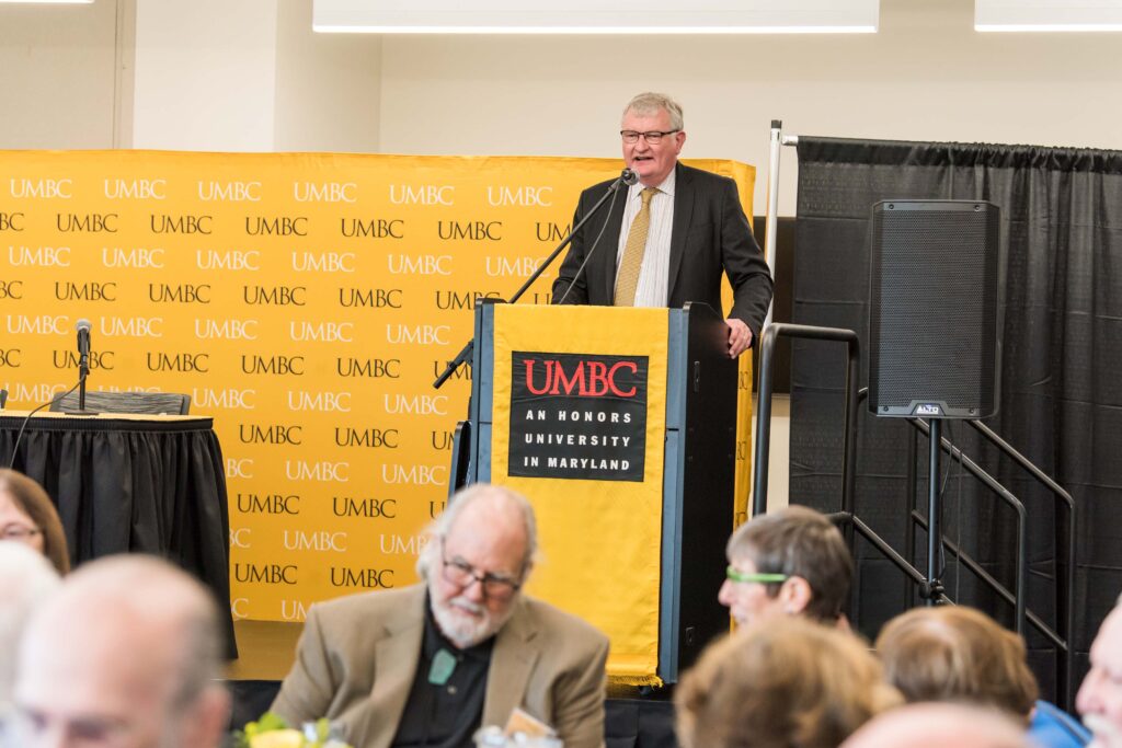 Provost Rous speaks behind UMBC podium