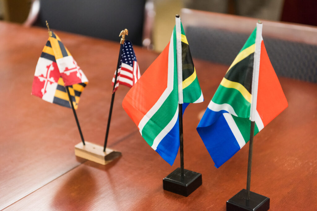 Maryland, U.S., and South African flags adorn the conference table at the partnership event.