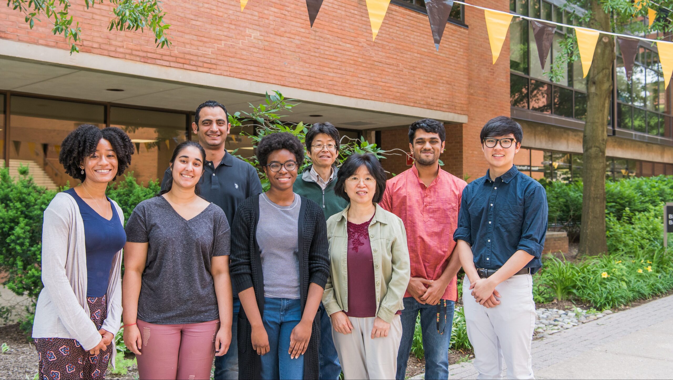A group of researchers in front of the UMBC biology building