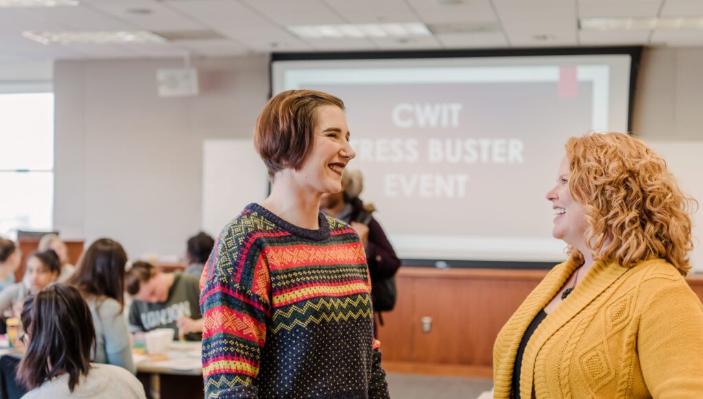 Victoria Herr, right, talking with CWIT's Cindy Greenwood during a stress buster event during finals.
