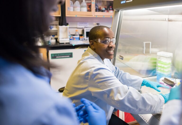 Naomi Mburu '18, UMBC’s first Rhodes Scholar, works in the lab with a faculty mentor.