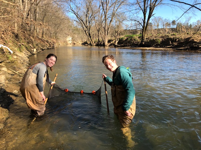 Natalie Roberts and Sam Hulse, grad students in biology, doing fieldwork.