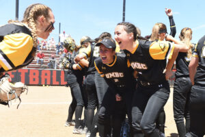 UMBC softball celebrates following the team’s America East victory.