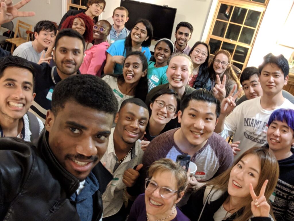 A large group of students poses for a selfie.