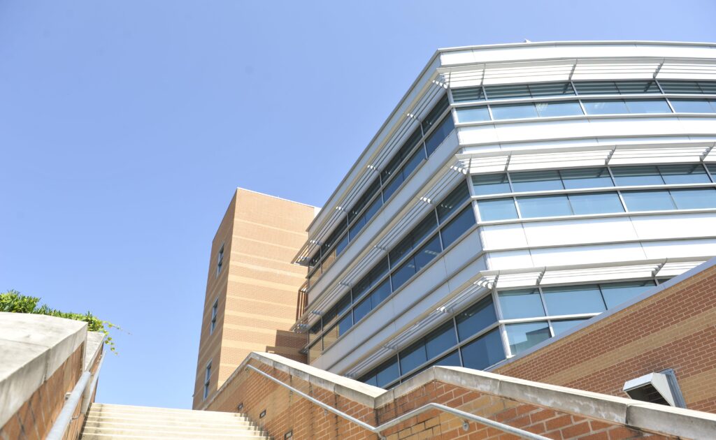 Metal, glass and brick building. Stairs  are in the foreground.