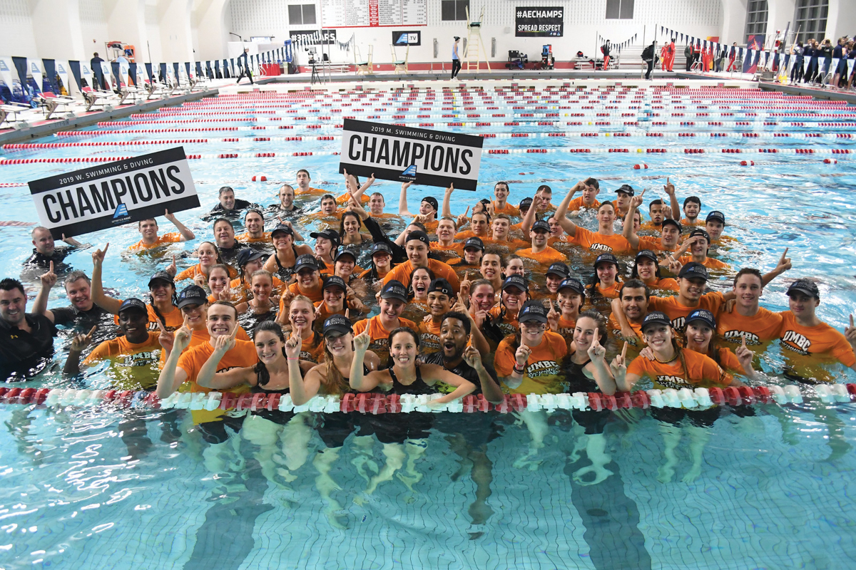 The teams celebrate their America East championships victory with a commemorative jump into the pool. Photo by Colleen Humel.