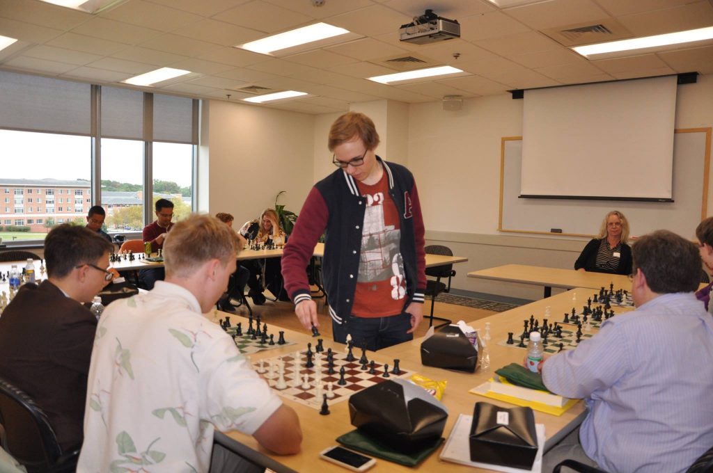 Ringoir, chess grandmaster, working with CTY students. Photo courtesy of Ringoir.