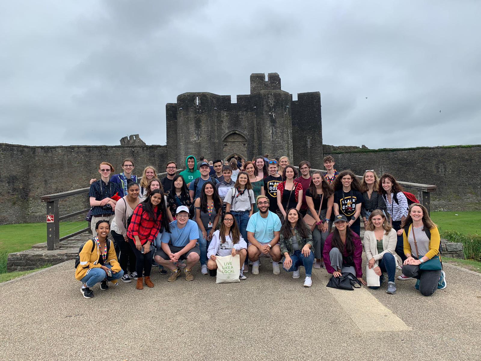 Students pose in front of castle