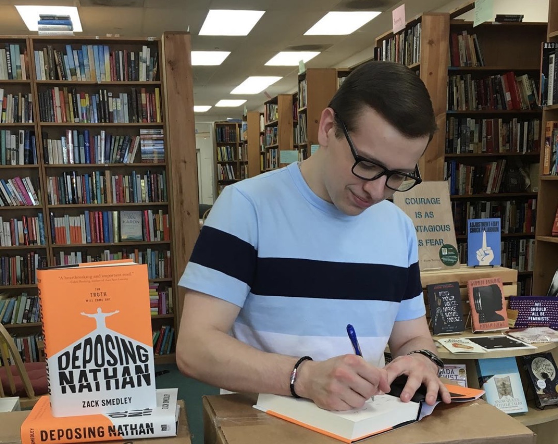 Zack Smedley '18 signs copies of his book. Photo courtesy of the author.