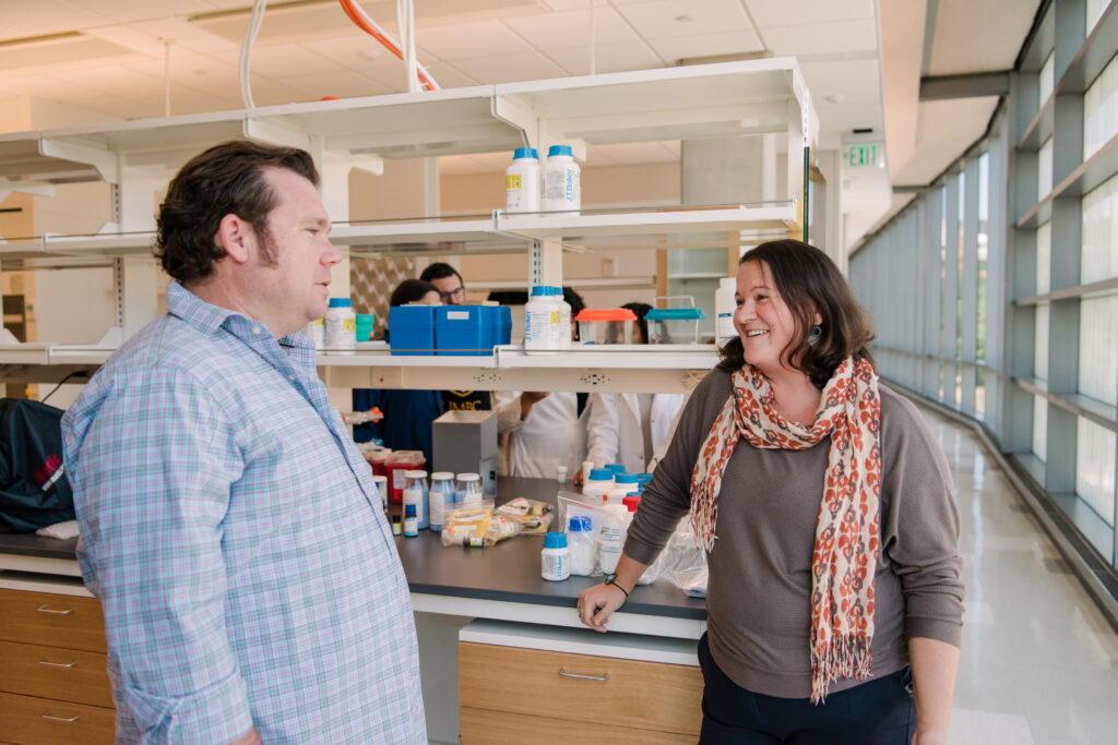 Two researchers in conversation in a lab