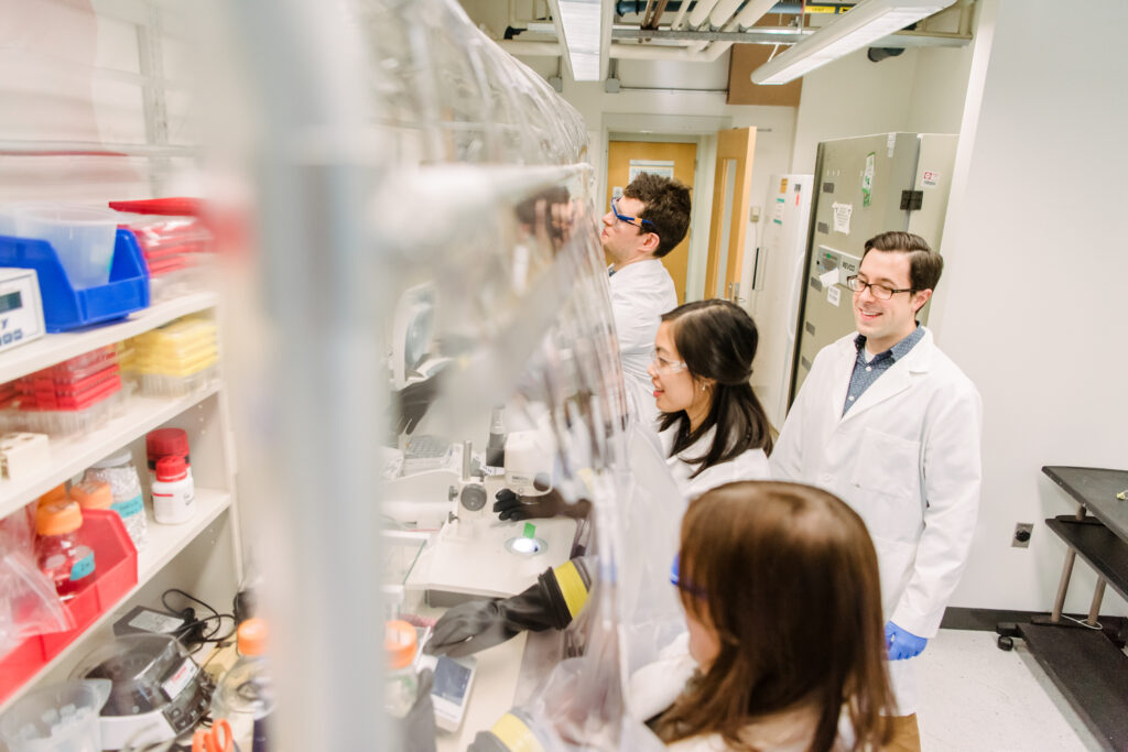 People wearing lab coats working together