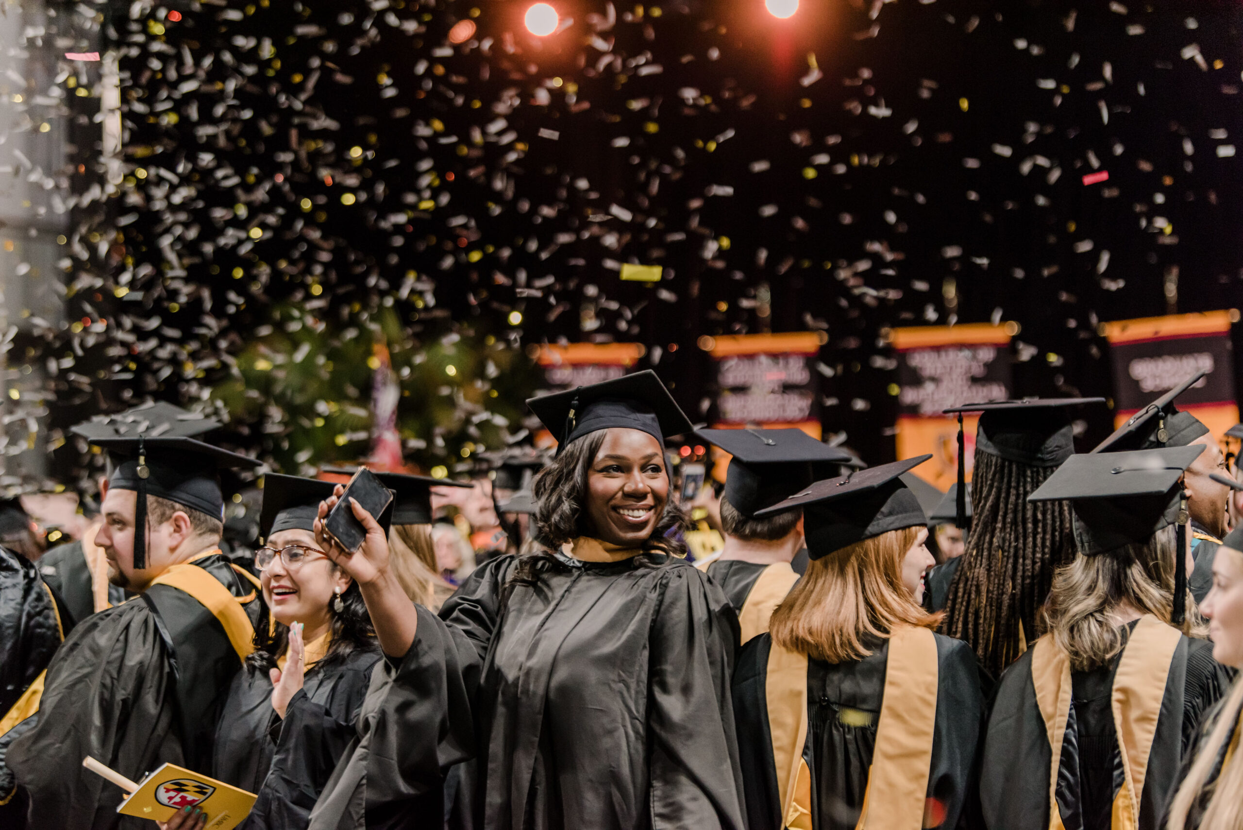 graduates smiling in confetti