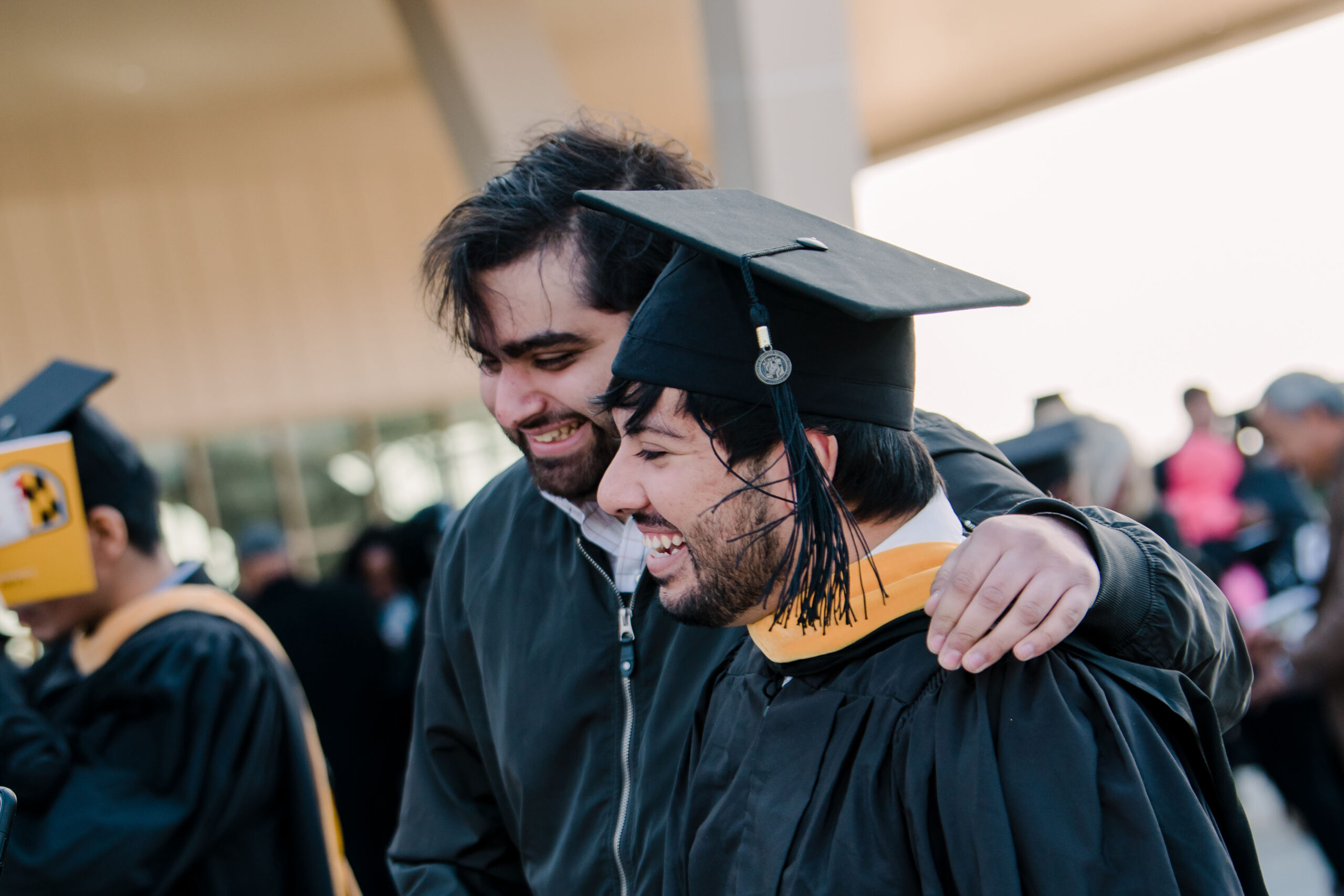 man happily walks alongside graduate