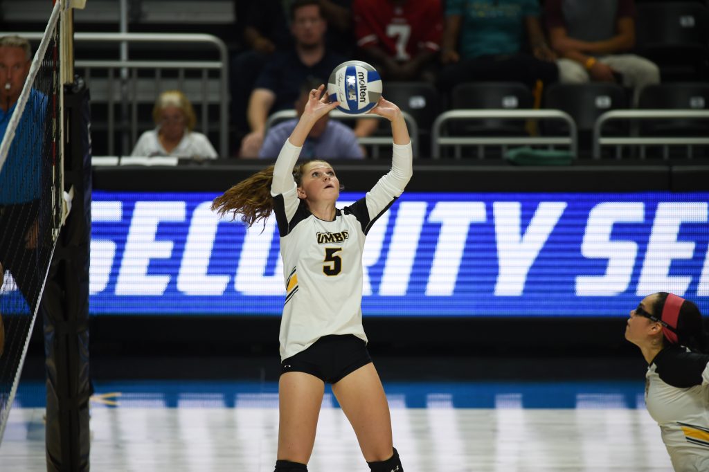 Taylor Dunn, in action on the court, about to hit a volleyball.