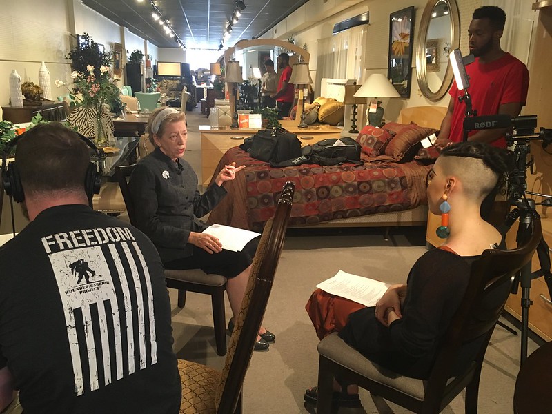 UMBC students interviewing a local business owner.