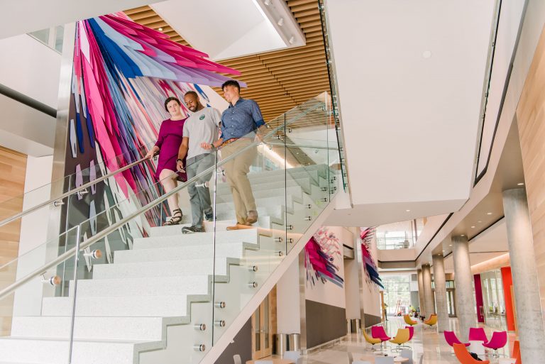 The ILSB atrium offers spaces to study or just relax. The art installation and a floating staircase add a whimsical, creative feel.