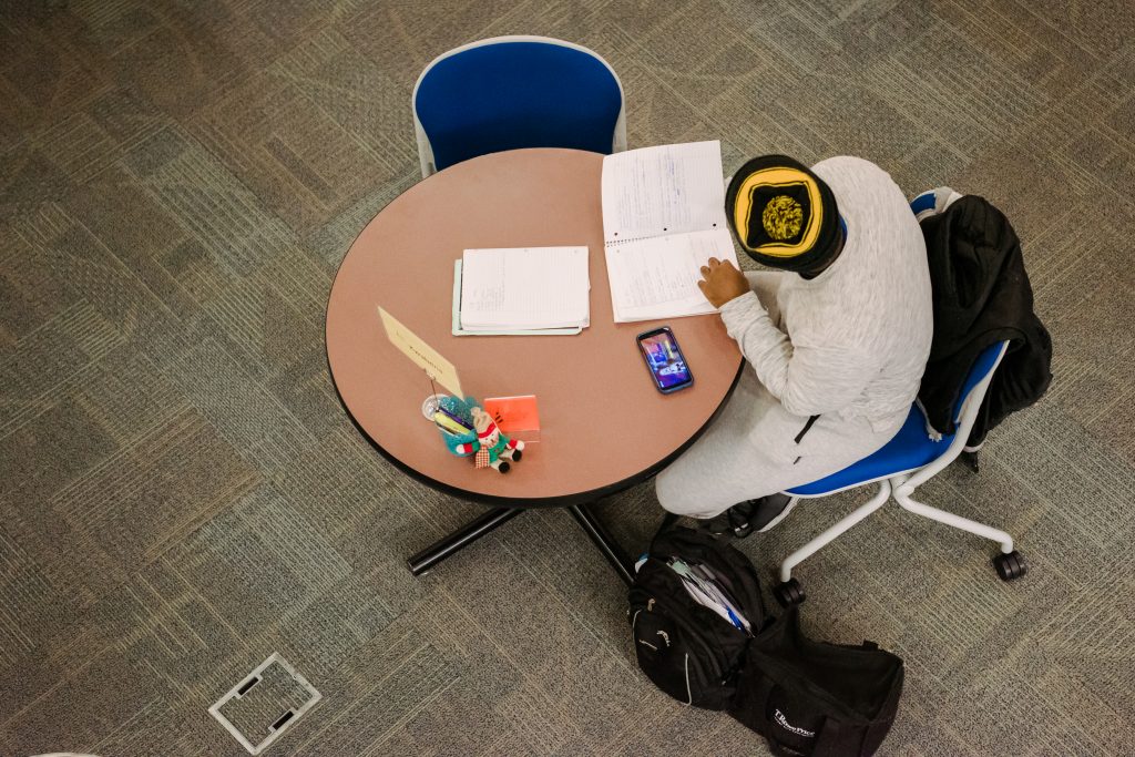 Bird's-eye-view of a student studying at a round table.