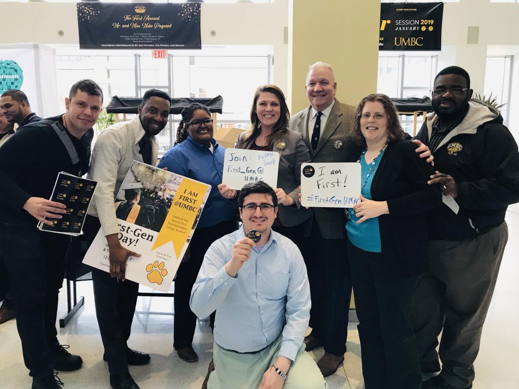 Staff members gather with signs