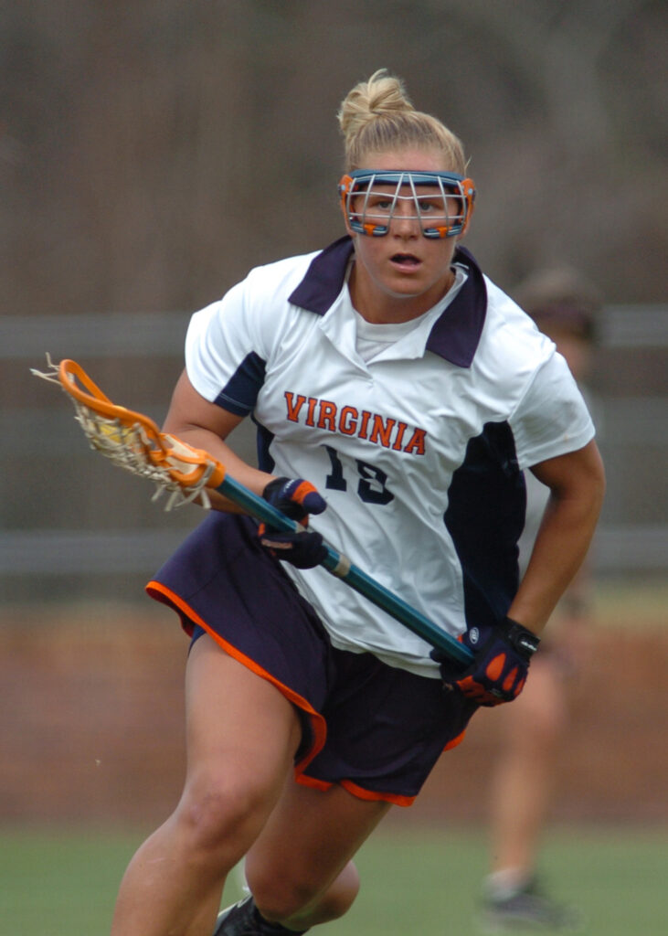 Amy Slade runs towards the camera in her University of Virginia lacrosse uniform during a game.