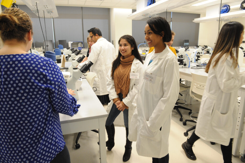Students in lab coats in a science laboratory.