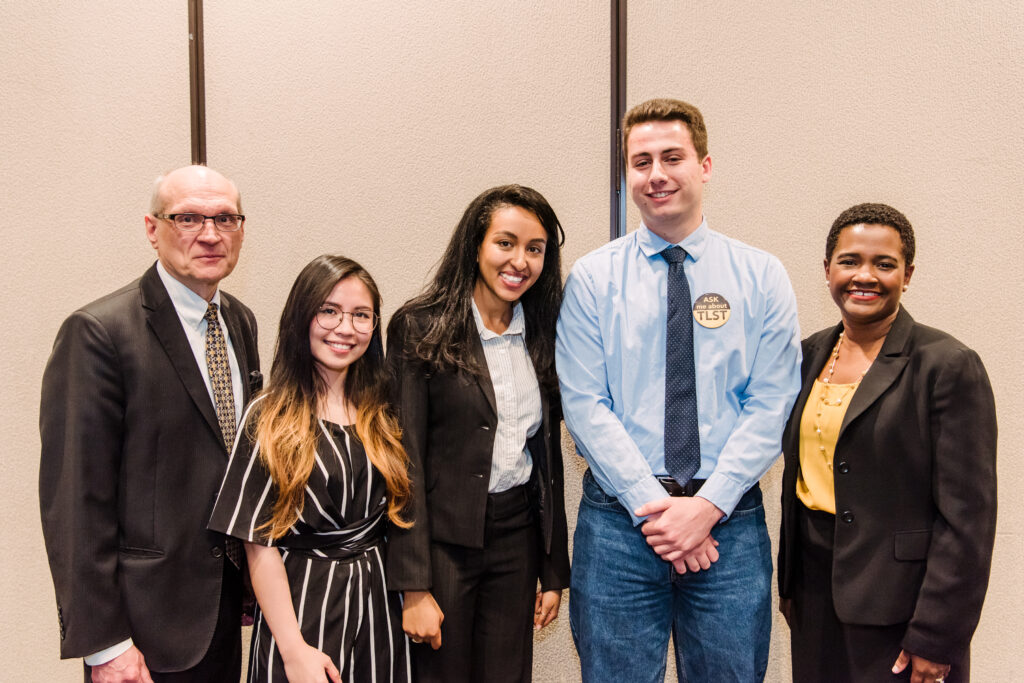 Group photo: two administrators and three students