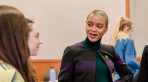 Women in conversation in a conference room.