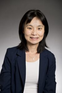 Headshot of woman wearing aqua sweater