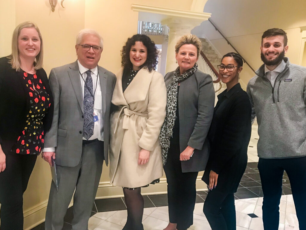 Wiggins, second from right, with Delegate Samuel Rosenberg, second from left, in Annapolis as a bill hearing. Photo courtesy of Wiggins.