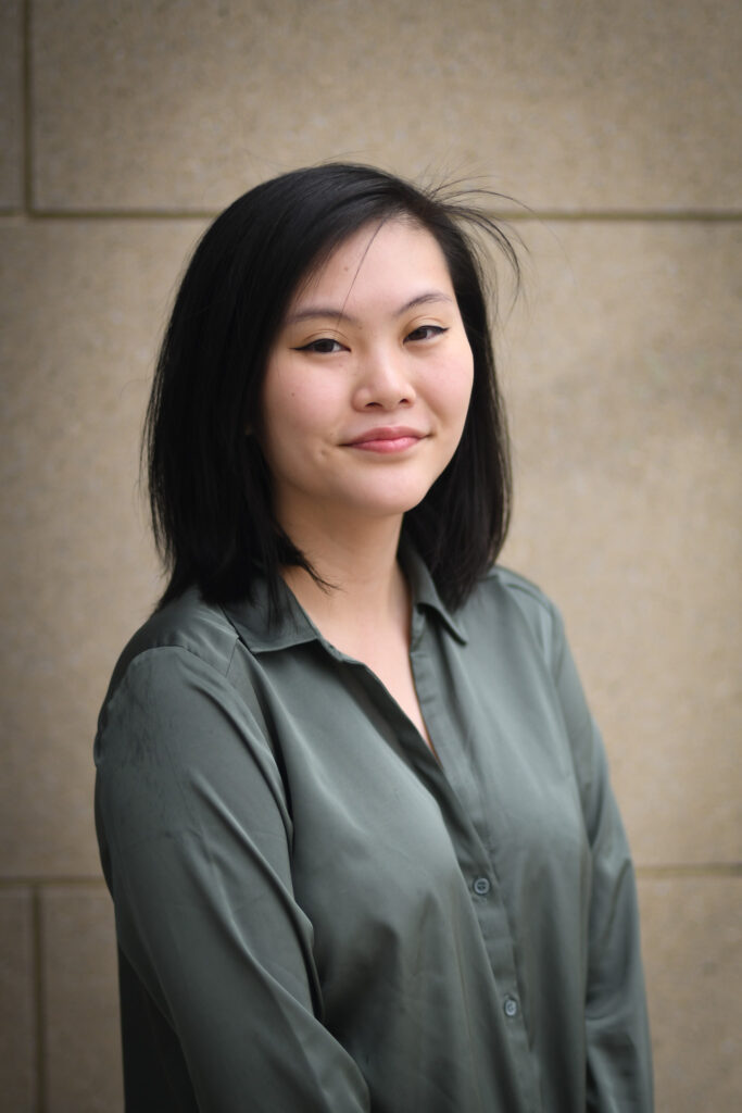 a professional headshot of a woman with shoulder length black hair