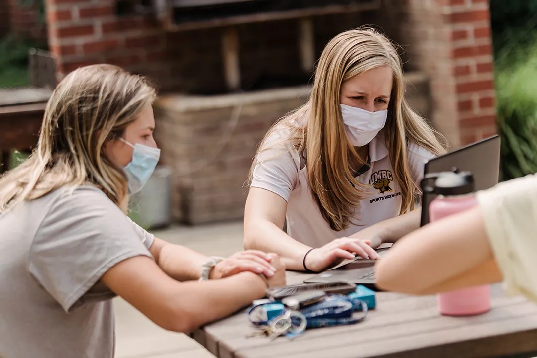 students working outside at a table