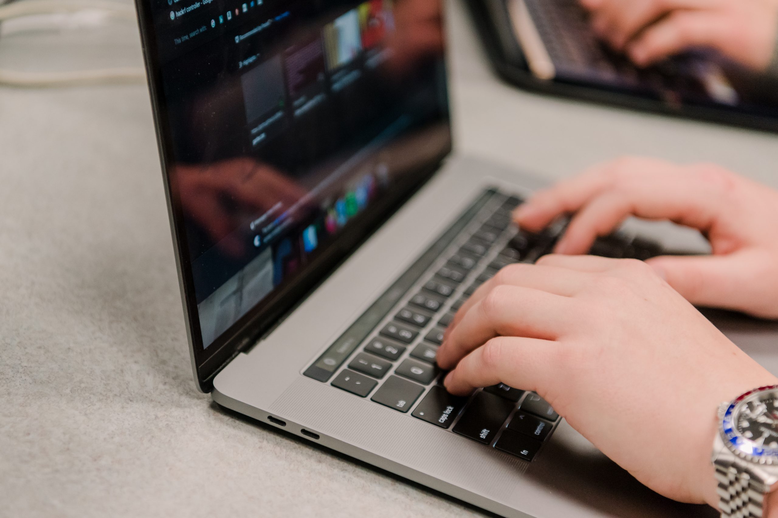 hands typing on a laptop keyboard