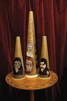 Trumpets with faces painted on them.